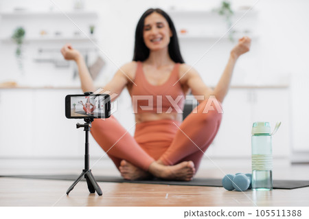 Female trainer shooting video about meditation indoors 105511388