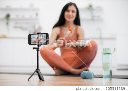 Woman filming video on smartphone about healthy eating Woman filming video on smartphone about healthy eating 105511389