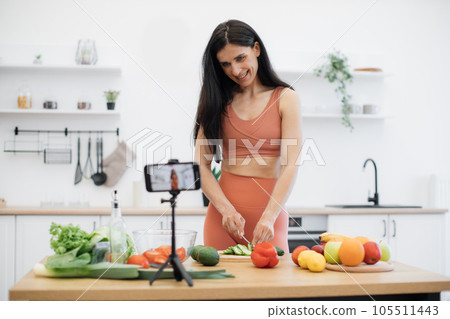Person preparing meal out of vegetable on cell phone camera Person preparing meal out of vegetable on cell phone camera 105511443