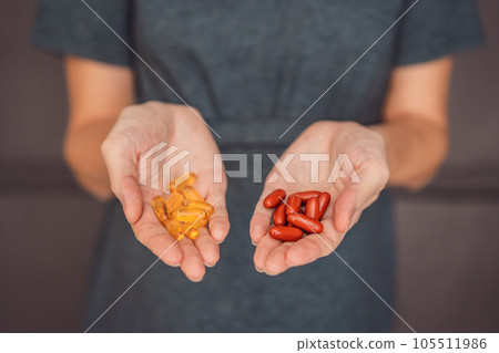 A happy and expectant mother holding omega 3 capsules, making a smart choice for her and her baby's health during pregnancy A happy and expectant mother holding omega 3 capsules, making a smart choice for her and her baby's health during pregnancy 105511986