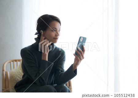 A woman listening to music A woman listening to music 105512438