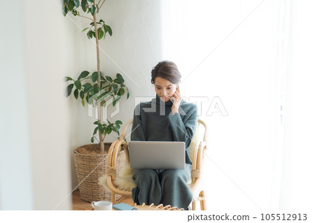 Woman operating a personal computer 105512913