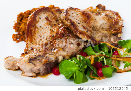 Pork chop with lentils and salad Pork chop with lentils and salad 105512945