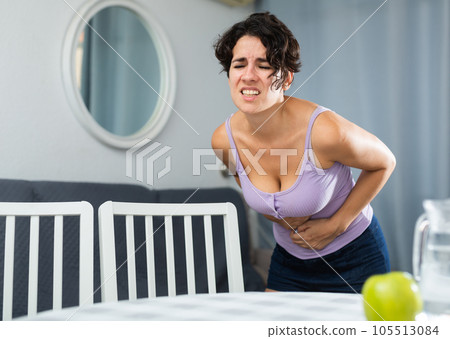 Young female having painful stomachache Young female having painful stomachache 105513084