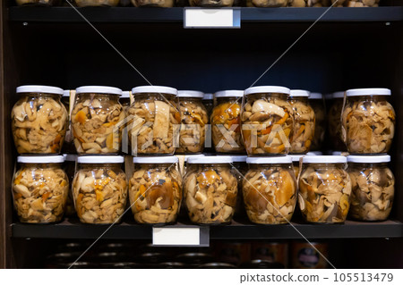Glass jars with pickled mushrooms 105513479