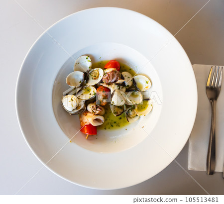 Popular Spanish dish Squid on a skewer with garlic Popular Spanish dish Squid on a skewer with garlic 105513481