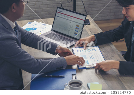 Two businesspeople meeting work at office desk. Teamwork partners team with Business strategy chart graph, infographic data financial report. Team partner planning marketing finance excel stat report Two businesspeople meeting work at office desk. Teamwork partners team with Business strategy chart graph, infographic data financial report. Team partner planning marketing finance excel stat report 105514770