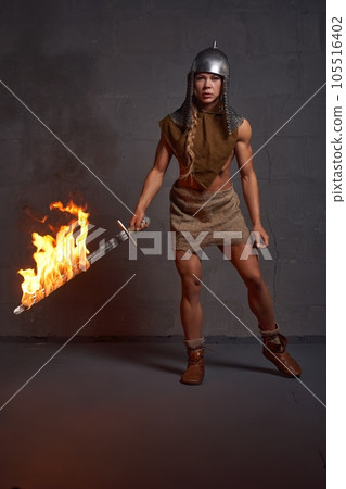 Knight woman with burning fire on grey background 105516402