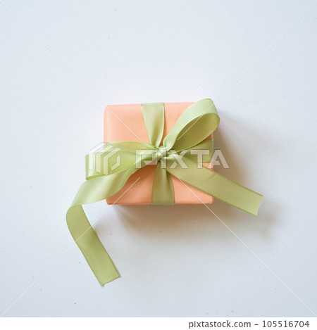 Coral gift box and yellow green ribbon isolated on white background. top view, copy space 105516704