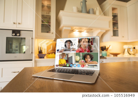 Laptop with video conference with diverse students on a table in the kitchen Laptop with video conference with diverse students on a table in the kitchen 105516949