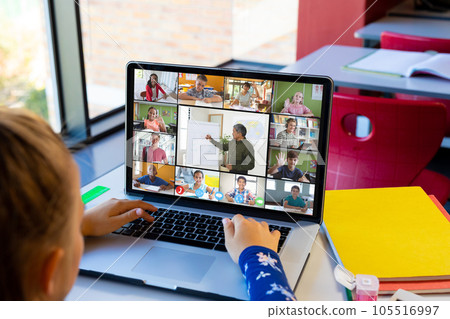 Caucasian girl having a video conference with male teacher and diverse students on laptop Caucasian girl having a video conference with male teacher and diverse students on laptop 105516997