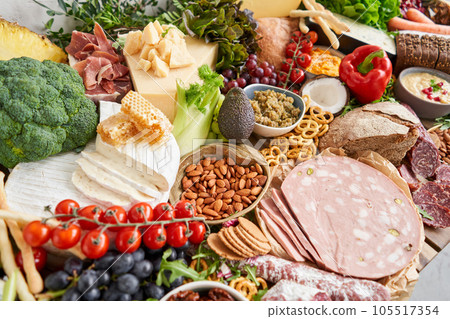 Fresh bread, pastries. Table full of mediterranean appetizers, tapas or antipasto. Assorted Italian food set. Delicious snack on party or picnic time. Italian style banquet.  Fresh bread, pastries. Table full of mediterranean appetizers, tapas or antipasto. Assorted Italian food set. Delicious snack on party or picnic time. Italian style banquet.  105517354