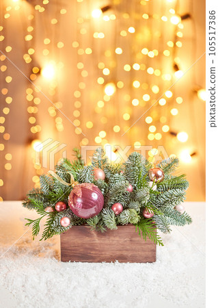 Floral arrangement with live spruce for decorating the house for the Christmas holidays. Christmas wooden box with fir branches for the holiday. The new year celebration. European flower shop 105517386