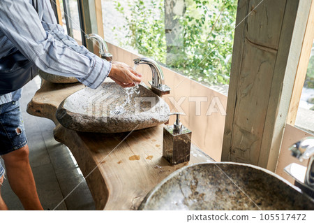 Teapot with tea and delicious National Kazakh pastries baursak. Street cafe in the highlands with a view of the mountains.. Fry dough in boiling oil in a frying pan. 105517472