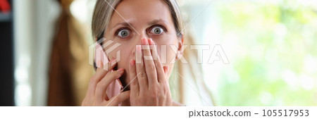 Stressed and shocked woman talking on smartphone and looking at camera. Stressed and shocked woman talking on smartphone and looking at camera. 105517953