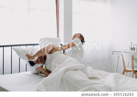 Funny couple morning wake up fight between wife and lazy husband. 105518283