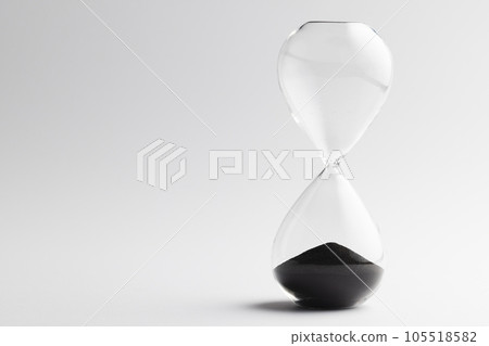 Close up of hourglass with black sand and copy space on white background 105518582