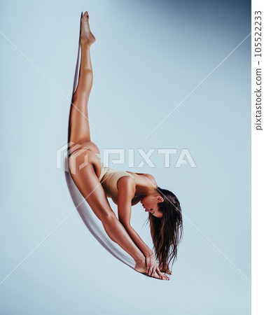 Woman gymnast stretching Woman gymnast stretching 105522233