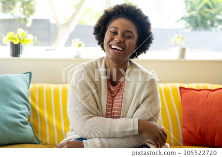 Happy plus size african american woman making video call at home Happy plus size african american woman making video call at home 105522720
