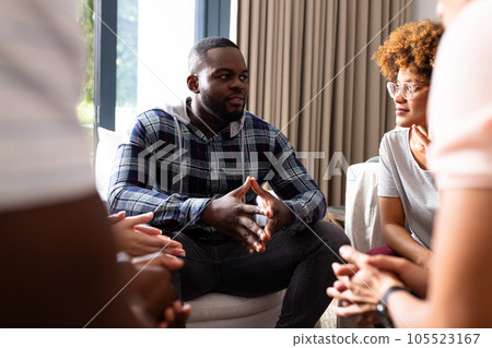 Diverse friends talking and listening to each other at group therapy session 105523167
