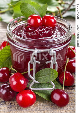 Domestic fresh cherry jam on a rustic wooden board Domestic fresh cherry jam on a rustic wooden board 105523331