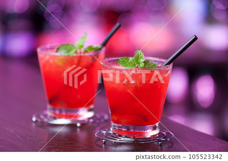 Two Mai Tai cocktail shot on a bar counter in a nightclub. Vertical shot 105523342