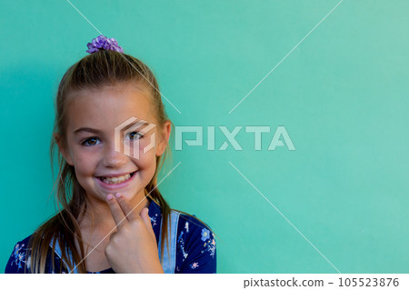 Caucasian schoolgirl with ponytail doing sign language gesture at elementary school, copy space Caucasian schoolgirl with ponytail doing sign language gesture at elementary school, copy space 105523876