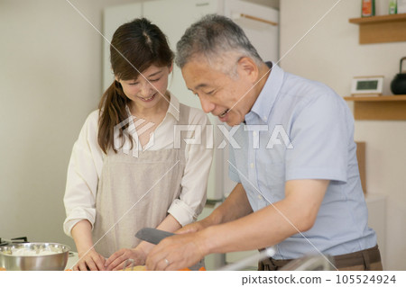 A couple cooking together in the kitchen A couple cooking together in the kitchen 105524924