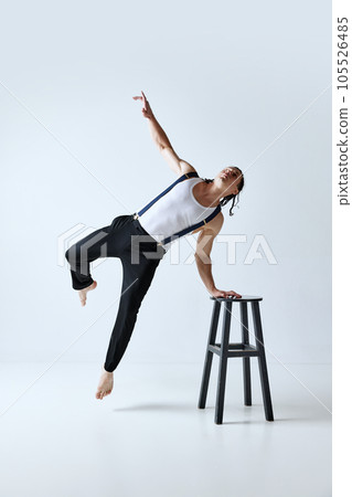 Portrait of handsome mature man with muscular body posing in stylish clothes against grey studio background Portrait of handsome mature man with muscular body posing in stylish clothes against grey studio background 105526485