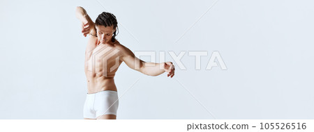 Mature man posing shirtless in underwear against grey studio background. Male model with muscular body shape Mature man posing shirtless in underwear against grey studio background. Male model with muscular body shape 105526516