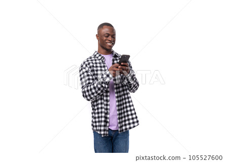 attractive young american guy dressed casual chatting on smartphone 105527600