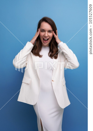 vertical portrait of a brunette woman in an elegant dress with a grimace and emotions on her face vertical portrait of a brunette woman in an elegant dress with a grimace and emotions on her face 105527609