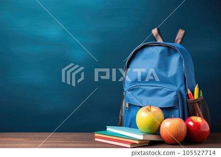 School bag and textbooks in front of a blue background. Back to school concept School bag and textbooks in front of a blue background. Back to school concept 105527714
