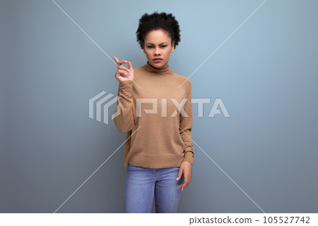 upset young woman with swarthy skin and fluffy hair over isolated background with copy space 105527742