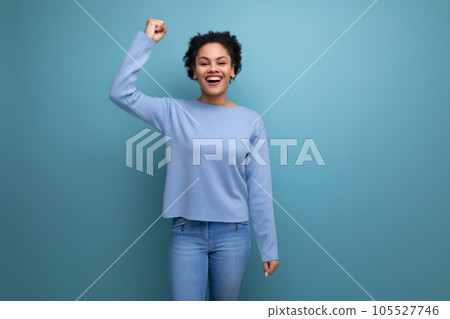 happy young brunette woman with afro curls won and rejoices happy young brunette woman with afro curls won and rejoices 105527746