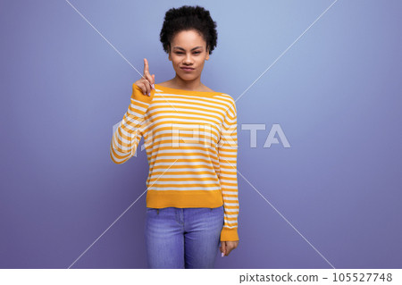 portrait of positive smart latin young woman with ponytail made of afro hair on background with copy portrait of positive smart latin young woman with ponytail made of afro hair on background with copy 105527748