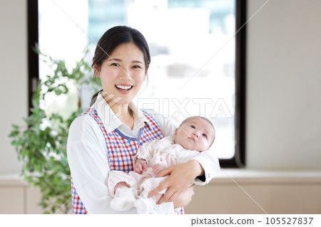 Nursery teacher baby hug 105527837