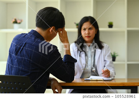 Male patient having consultation with psychologist at medical appointment. Psychotherapy and mental health concept Male patient having consultation with psychologist at medical appointment. Psychotherapy and mental health concept 105528961