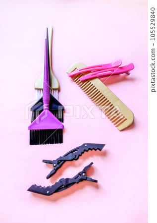 Several items of a hairdresser for coloring and hair care on a soft pink background. Vertical photo Several items of a hairdresser for coloring and hair care on a soft pink background. Vertical photo 105529840