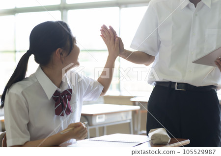 High school girl high five with classmate 105529987