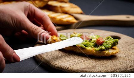 Bruschettas with guacamole and cherry tomatoes 105531135
