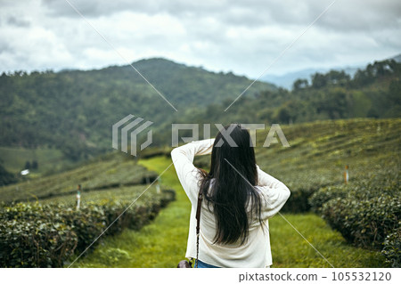 Rear view image of  a female traveler taking photos 105532120