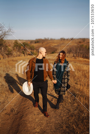 Lovely hipster couple resting in nature. People, lifestyle, relaxation and vacations concept. 105533650