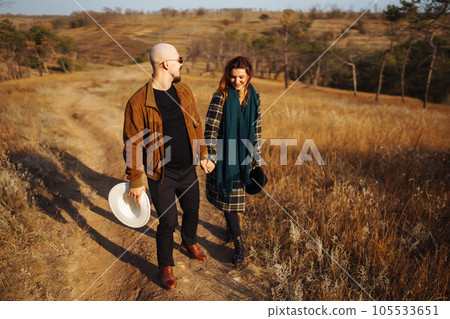 Lovely hipster couple enjoying each other in the autumn park. Nice autumn day. love and lifestyle. 105533651