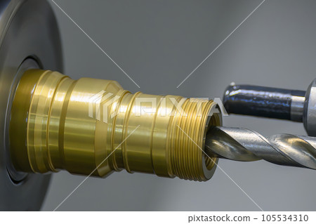 The  CNC lathe machine boring  cutting the brass material parts by drill tool. 105534310