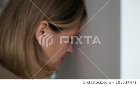 Desperate woman blunts against wall and worrying about problems at work Desperate woman blunts against wall and worrying about problems at work 105534471