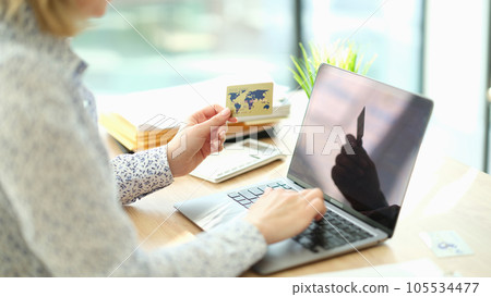 Woman shopping online and using laptop Woman shopping online and using laptop 105534477