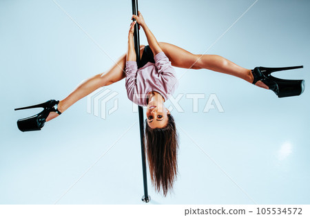 Young woman pole dancing 105534572