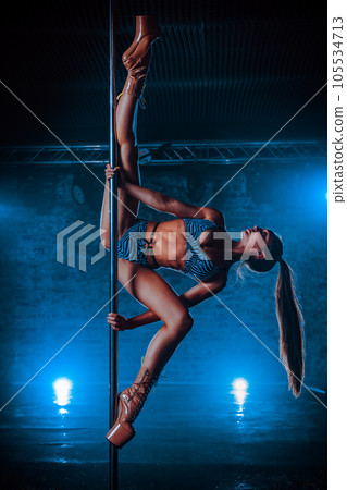 Young woman pole dancing Young woman pole dancing 105534713