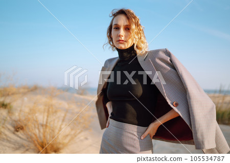 Fashion Model posing near the sea. Young woman resting in nature. People, lifestyle, relaxation. 105534787